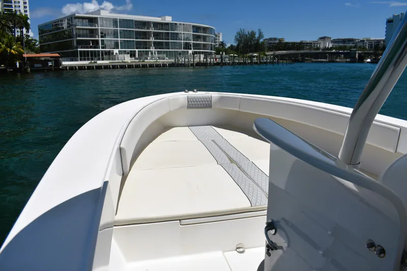  Yacht Photos Pics 2005 Venture 39 Open boat on water, modern buildings in background.