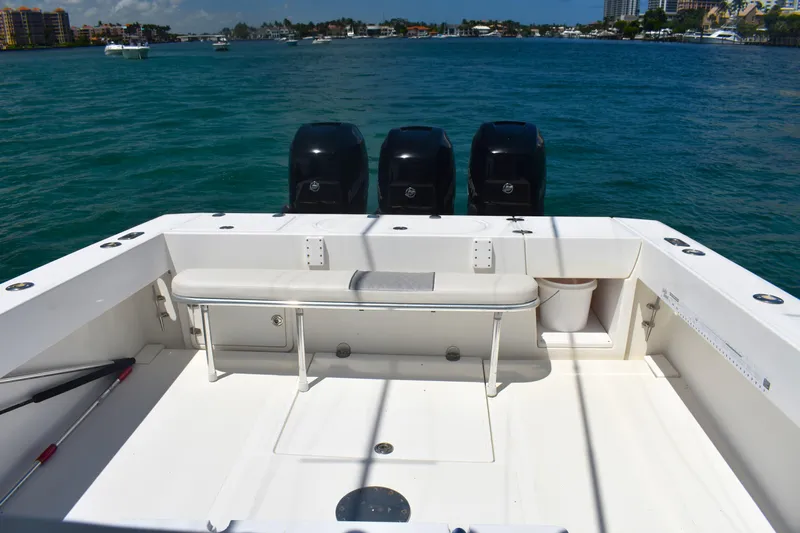  Yacht Photos Pics 2005 Venture 39 Open boat with triple outboard motors on a sunny day.