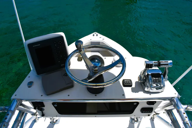  Yacht Photos Pics 2005 Venture 39 Open boat helm with steering wheel and controls on clear water.