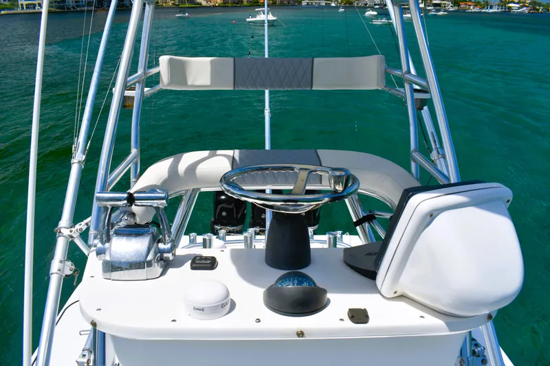  Yacht Photos Pics 2005 Venture 39 Open boat helm with steering wheel and controls on turquoise water.