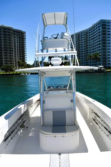  Yacht Photos Pics 2005 Venture 39 Open boat on water, with cityscape background.