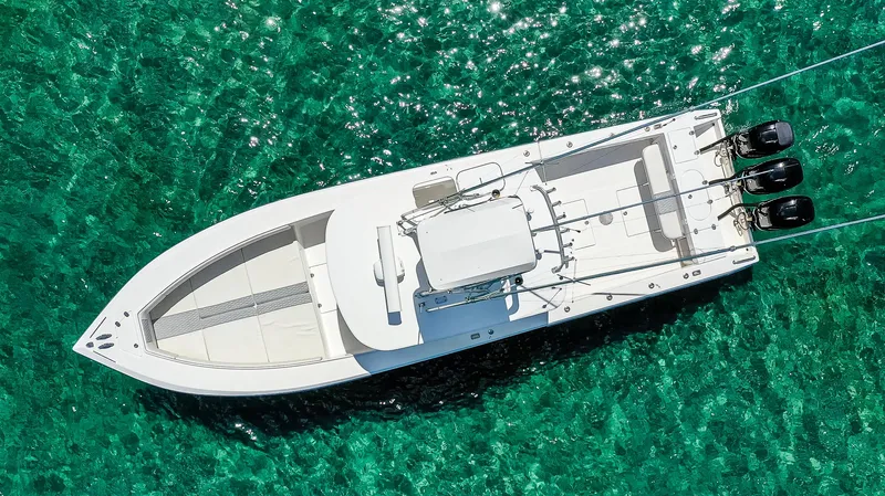  Yacht Photos Pics Aerial view of 2005 Venture 39 Open boat on clear turquoise water.