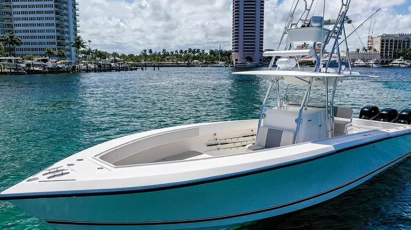  Yacht Photos Pics 2005 Venture 39 Open boat on clear water near city skyline.