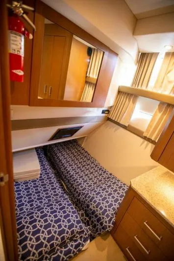 Tropical Life Yacht Photos Pics 2012 Carver Sojourn cabin interior with twin beds and wooden cabinetry.