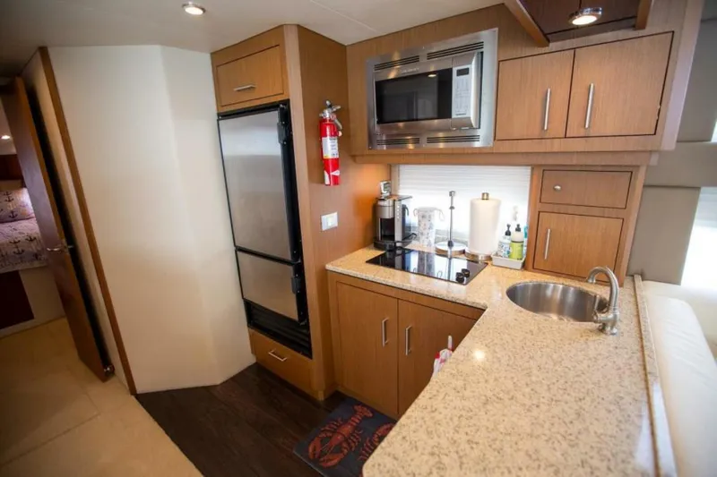 Tropical Life Yacht Photos Pics Compact kitchen in 2012 Carver Sojourn yacht with modern appliances and wood cabinetry.