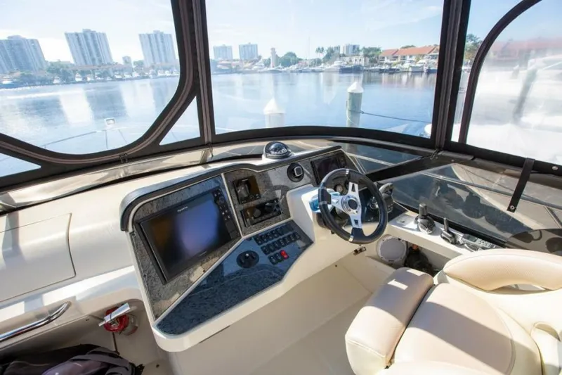 Tropical Life Yacht Photos Pics Interior of 2012 Carver Sojourn boat with modern dashboard and waterfront view.