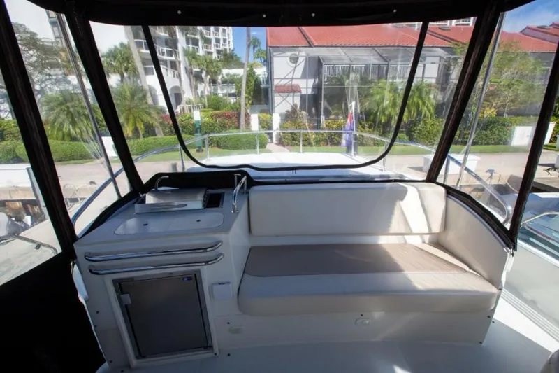 Tropical Life Yacht Photos Pics Interior view of 2012 Carver Sojourn yacht with seating and kitchenette.