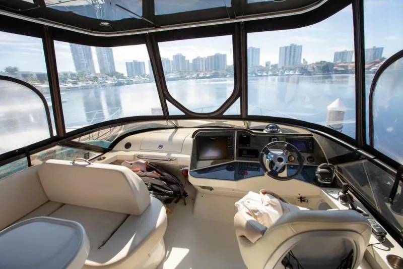 Tropical Life Yacht Photos Pics Interior of 2012 Carver Sojourn yacht with city skyline view through large windows.