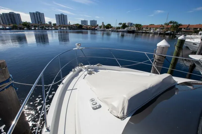 Tropical Life Yacht Photos Pics Bow of 2012 Carver Sojourn yacht docked in a marina with city skyline.