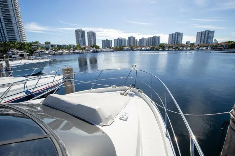 Tropical Life Yacht Photos Pics 2012 Carver Sojourn yacht docked in a marina with city skyline in the background.