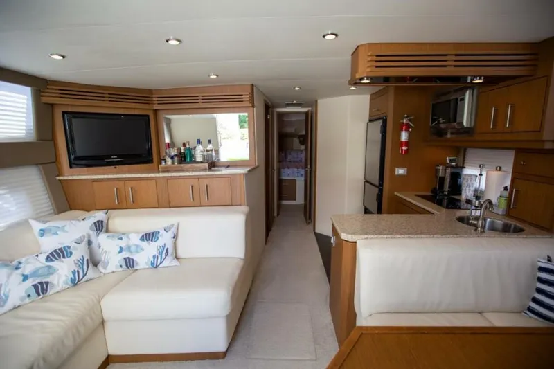 Tropical Life Yacht Photos Pics Luxurious interior of 2012 Carver Sojourn yacht with modern kitchen and cozy seating area.