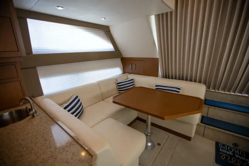 Tropical Life Yacht Photos Pics Luxurious interior of 2012 Carver Sojourn yacht with cozy seating and elegant table.