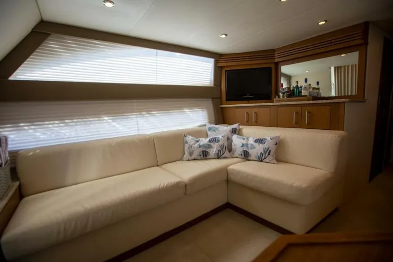 Tropical Life Yacht Photos Pics Luxurious interior of 2012 Carver Sojourn yacht with cream sofa and decorative pillows.
