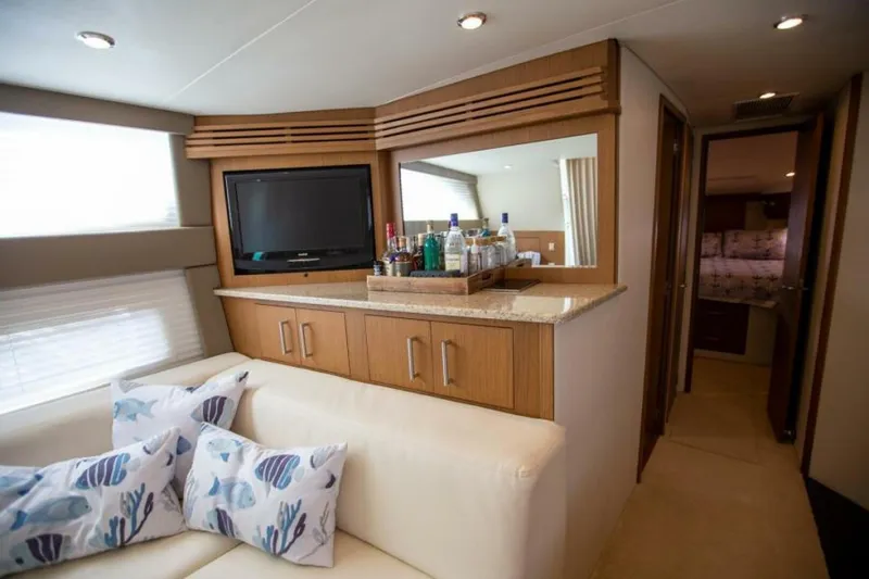Tropical Life Yacht Photos Pics Luxurious interior of 2012 Carver Sojourn yacht with TV, bar, and cozy seating.