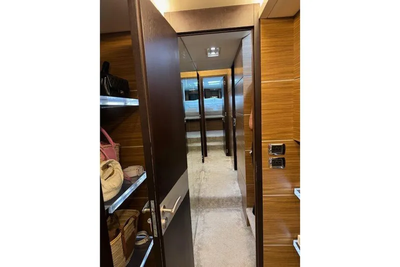  Yacht Photos Pics Luxurious interior of 2007 Astondoa A 76 GLX yacht with wooden finishes and shelving.