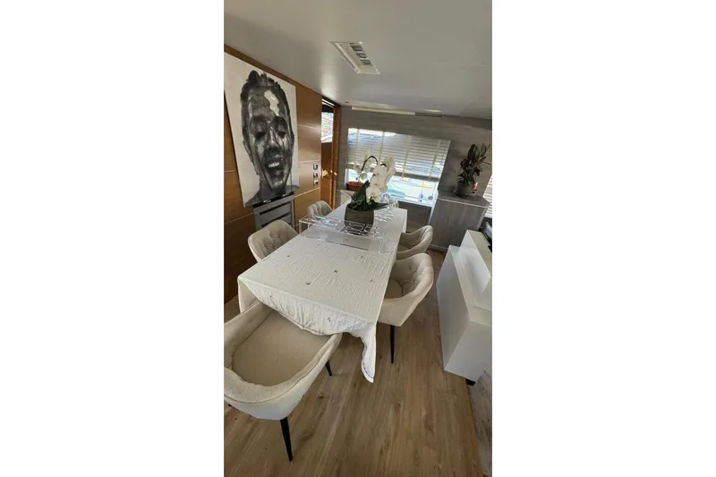  Yacht Photos Pics Luxurious dining area on 2007 Astondoa A 76 GLX yacht with elegant decor and artwork.