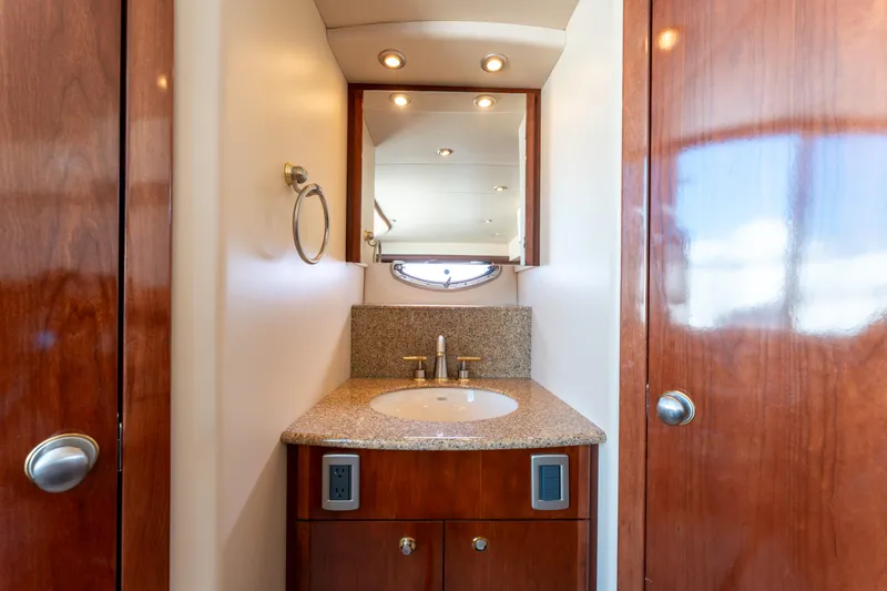 Summer Breeze Yacht Photos Pics Luxurious bathroom in 2008 Meridian 459 Motoryacht with granite countertop and wooden cabinetry.