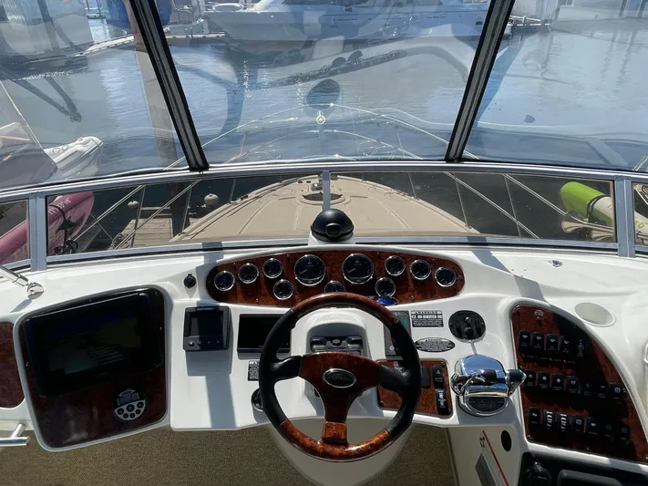 Summer Breeze Yacht Photos Pics 2008 Meridian 459 Motoryacht helm with steering wheel, gauges, and navigation controls.