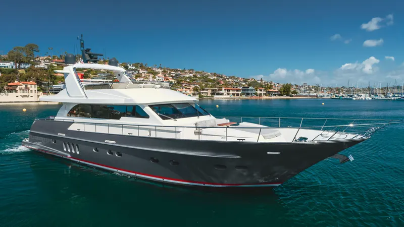 Gyrfalcon Yacht Photos Pics 2016 Van der Valk 78 Flybridge Motor Yacht cruising in a scenic harbor.