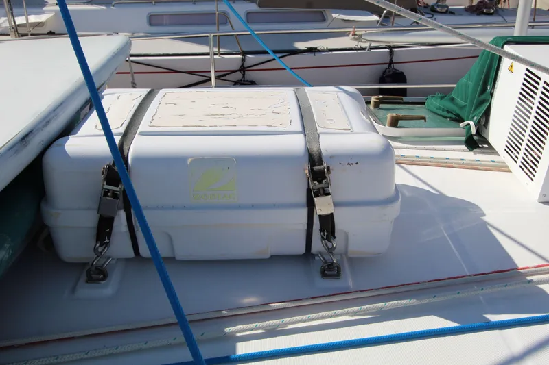 Oya Yacht Photos Pics Life raft on deck of 2001 Beneteau Oceanis 461 sailboat, secured with straps.