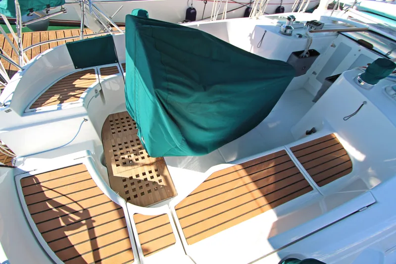 Oya Yacht Photos Pics Cockpit of 2001 Beneteau Oceanis 461 sailboat with teak flooring and green covers.