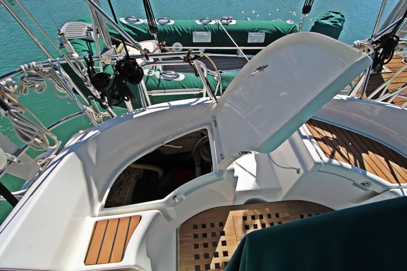 Oya Yacht Photos Pics Beneteau Oceanis 461 sailboat cockpit with open hatch, showcasing teak flooring and rigging.