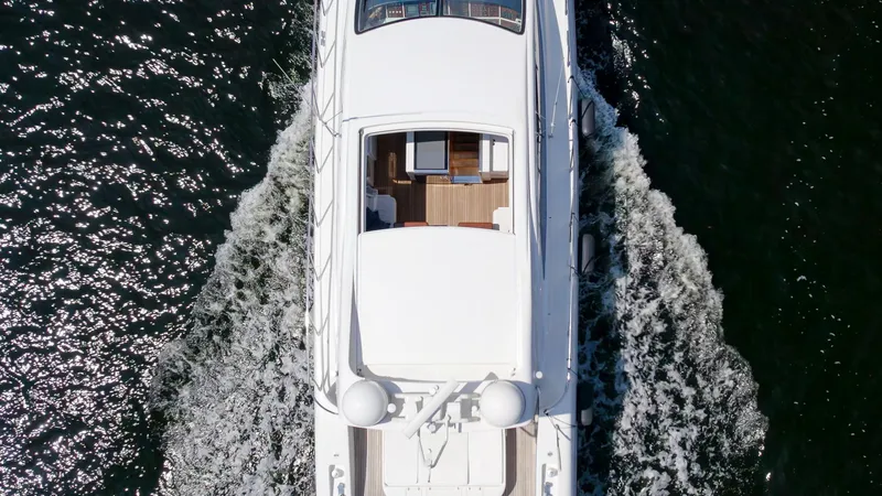 Gabriela G Yacht Photos Pics Aerial view of 2001 Mangusta 72 yacht cruising on water.