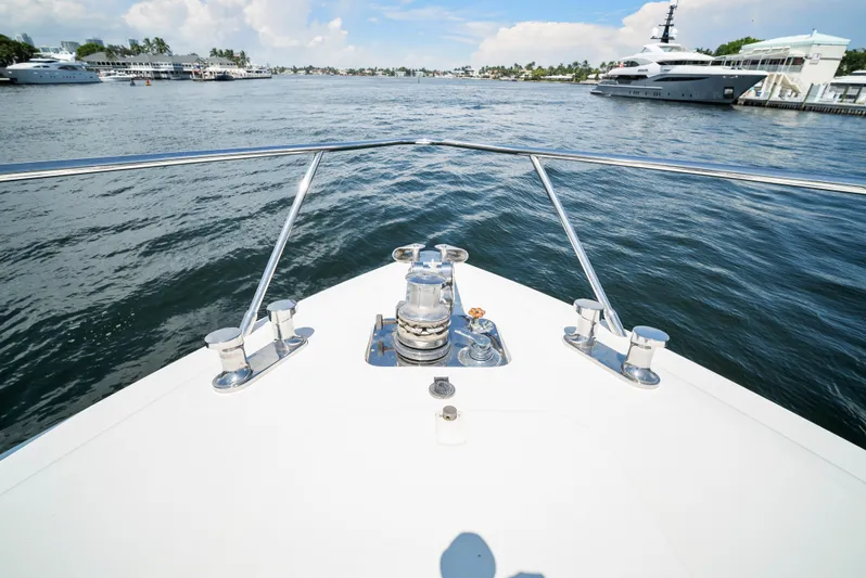 Gabriela G Yacht Photos Pics Bow view of 2001 Mangusta 72 yacht on calm waters, with luxury vessels nearby.