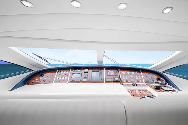 Gabriela G Yacht Photos Pics Cockpit of 2001 Mangusta 72 yacht with modern navigation instruments and panoramic view.