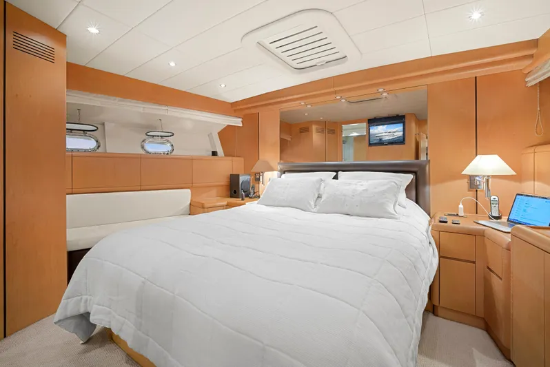 Gabriela G Yacht Photos Pics Luxurious bedroom interior of 2001 Mangusta 72 yacht with modern furnishings and ambient lighting.