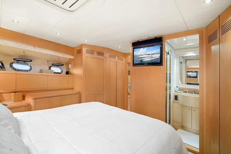 Gabriela G Yacht Photos Pics Luxurious bedroom interior of 2001 Mangusta 72 yacht with modern amenities and elegant design.