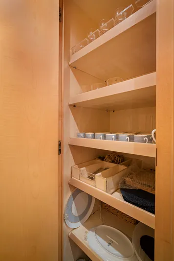 Gabriela G Yacht Photos Pics Wooden cabinet with neatly organized dishes and glassware on shelves. Mangusta 72, 2001 model.