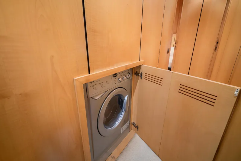 Gabriela G Yacht Photos Pics Built-in washing machine in 2001 Mangusta 72 yacht's wooden cabinet.