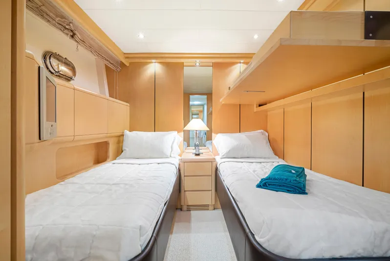 Gabriela G Yacht Photos Pics Luxurious twin cabin interior of 2001 Mangusta 72 yacht with modern wooden design.