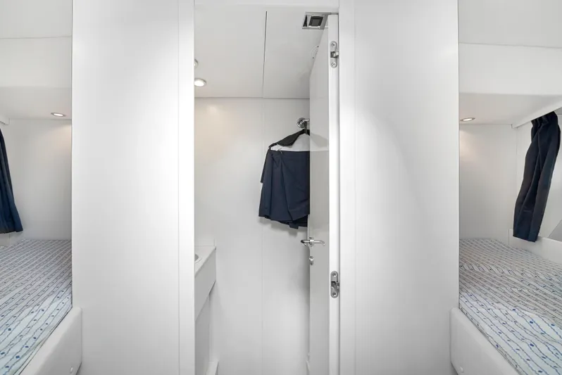 Gabriela G Yacht Photos Pics Luxurious Mangusta 72 yacht interior, featuring a sleek, modern cabin with twin beds, 2001 model.