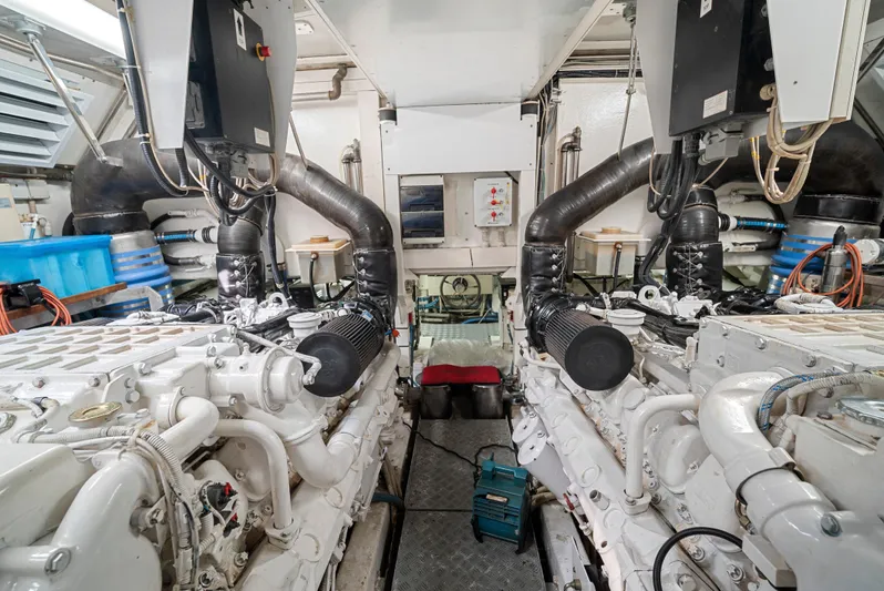 Gabriela G Yacht Photos Pics Engine room of a 2001 Mangusta 72 yacht, showcasing dual engines and mechanical components.