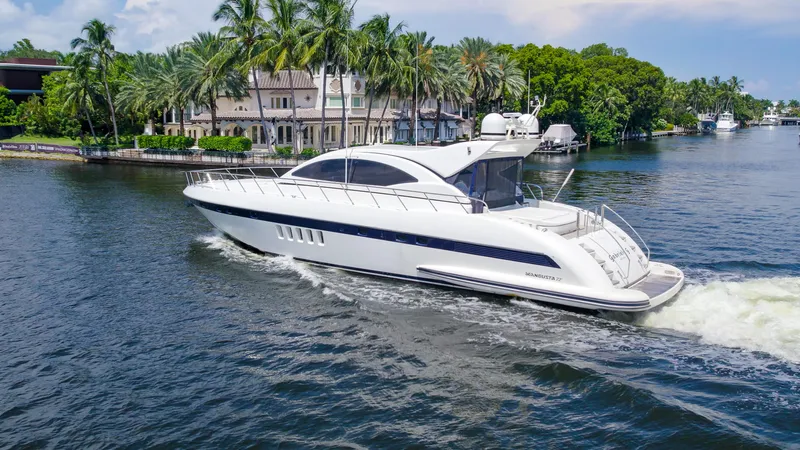 Gabriela G Yacht Photos Pics Luxury 2001 Mangusta 72 yacht cruising on a scenic waterway.