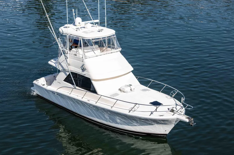 Sunny 1 Yacht Photos Pics 2001 Riviera 36 Flybridge yacht cruising on calm waters.