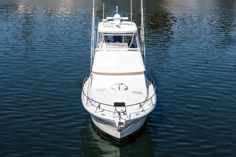 Sunny 1 Yacht Photos Pics 2001 Riviera 36 Flybridge yacht on calm water, front view.