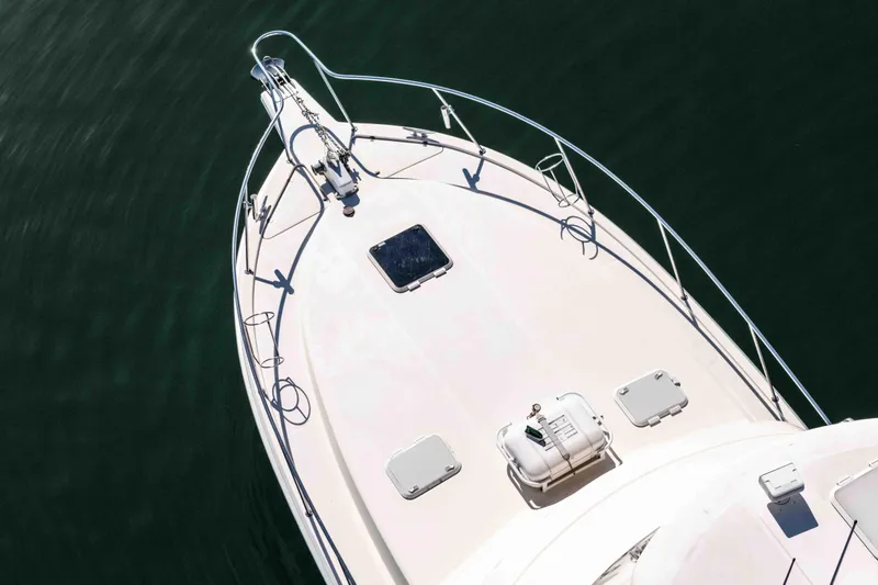 Sunny 1 Yacht Photos Pics 2001 Riviera 36 Flybridge yacht deck, aerial view, on calm water.