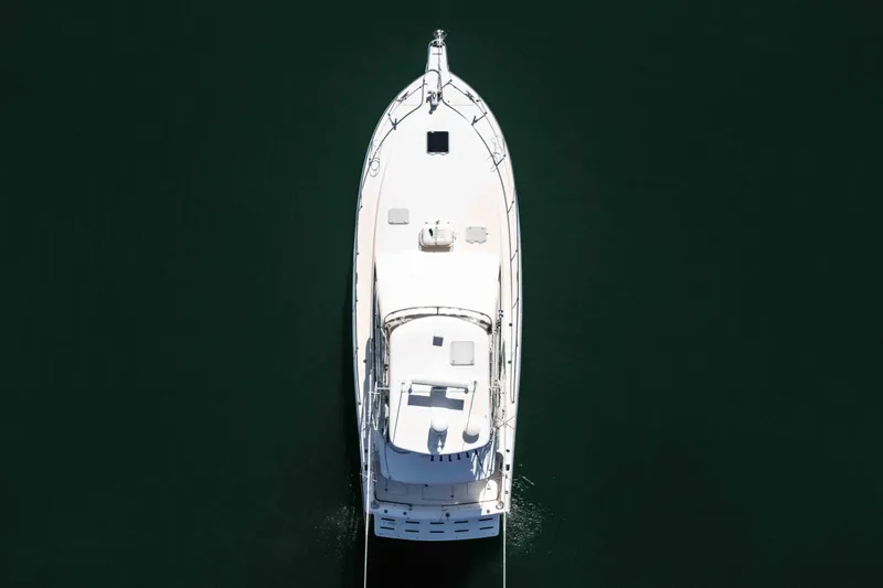 Sunny 1 Yacht Photos Pics Aerial view of 2001 Riviera 36 Flybridge yacht on dark water.