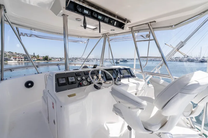 Sunny 1 Yacht Photos Pics Flybridge of 2001 Riviera 36 yacht with modern controls and ocean view.