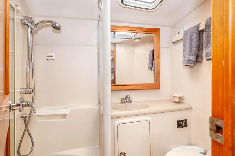 Sunny 1 Yacht Photos Pics Bathroom interior of 2001 Riviera 36 Flybridge yacht with shower and sink.