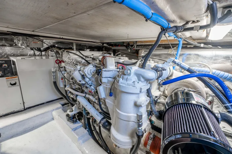 Sunny 1 Yacht Photos Pics Engine room of 2001 Riviera 36 Flybridge yacht, showcasing detailed mechanical components.
