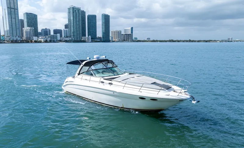 Genesis Yacht Photos Pics 2003 Sea Ray 380 Sundancer yacht cruising near city skyline.