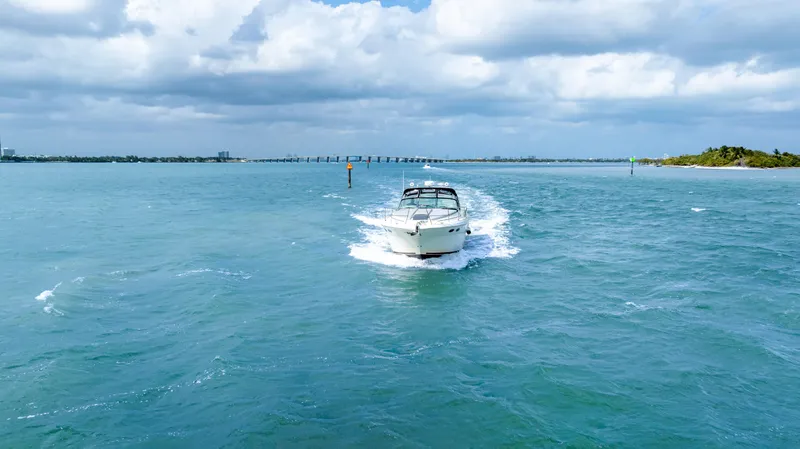 Genesis Yacht Photos Pics 2003 Sea Ray 380 Sundancer cruising on open water under cloudy skies.