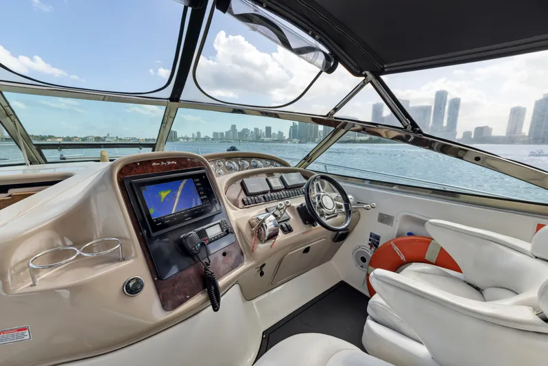 Genesis Yacht Photos Pics Helm of 2003 Sea Ray 380 Sundancer with city skyline view.