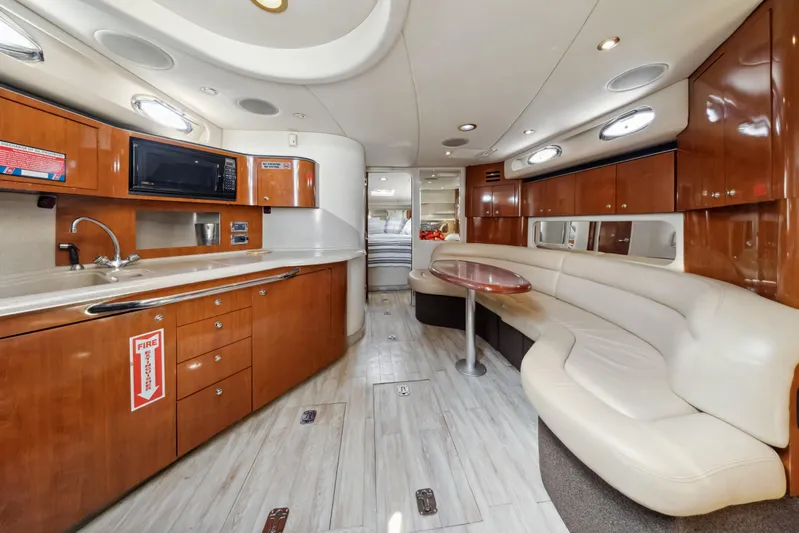 Genesis Yacht Photos Pics Luxurious interior of 2003 Sea Ray 380 Sundancer yacht with kitchen and seating area.