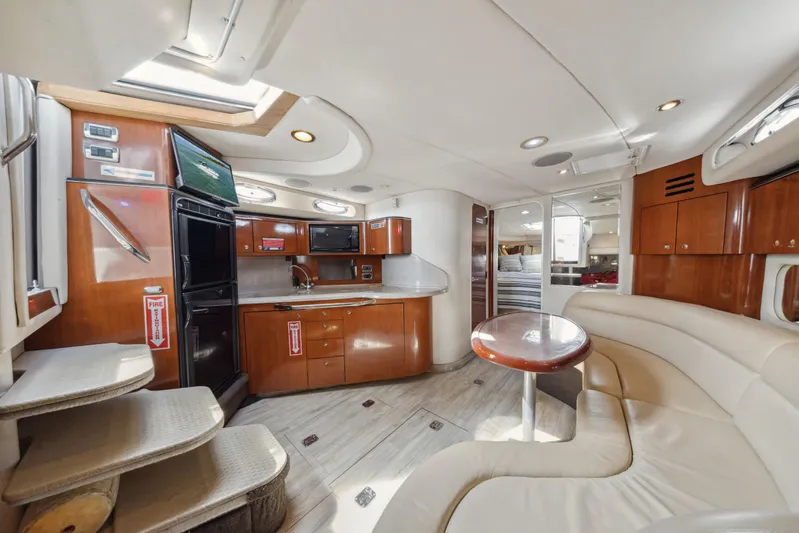 Genesis Yacht Photos Pics Luxurious interior of 2003 Sea Ray 380 Sundancer yacht with modern kitchen and seating area.