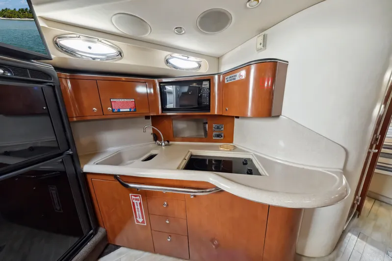 Genesis Yacht Photos Pics 2003 Sea Ray 380 Sundancer yacht kitchen with wood cabinets and modern appliances.
